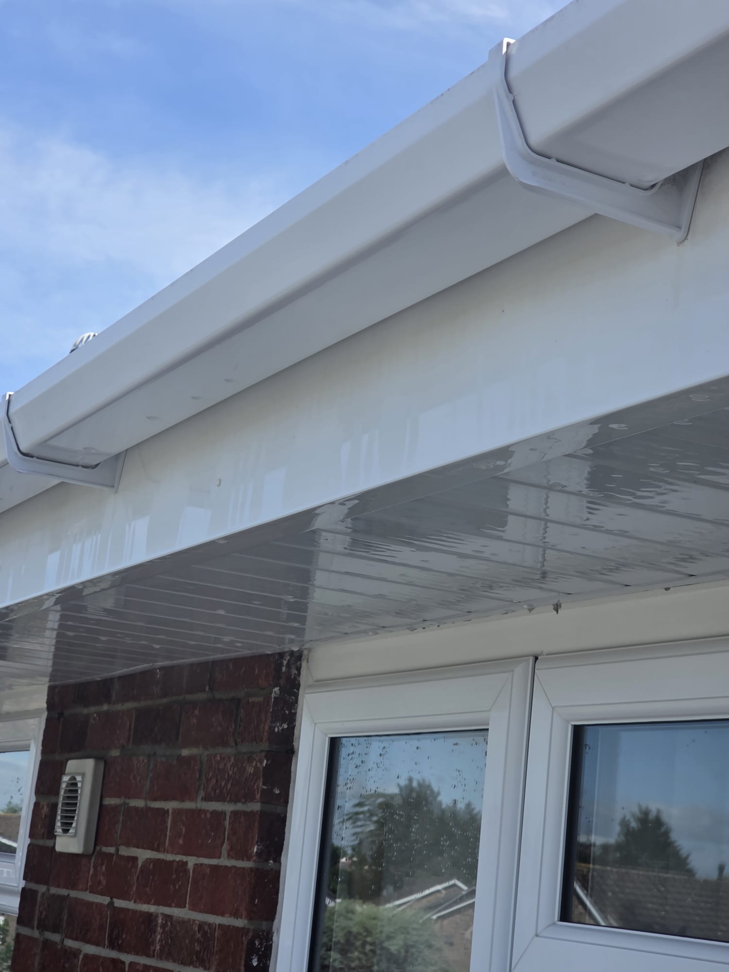 White uPVC fascia, soffit and guttering after exterior soft-wash cleaning