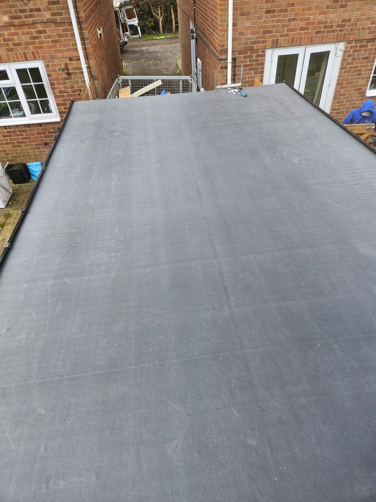 EPDM flat roof finished against a brick parapet with neat black edge trim