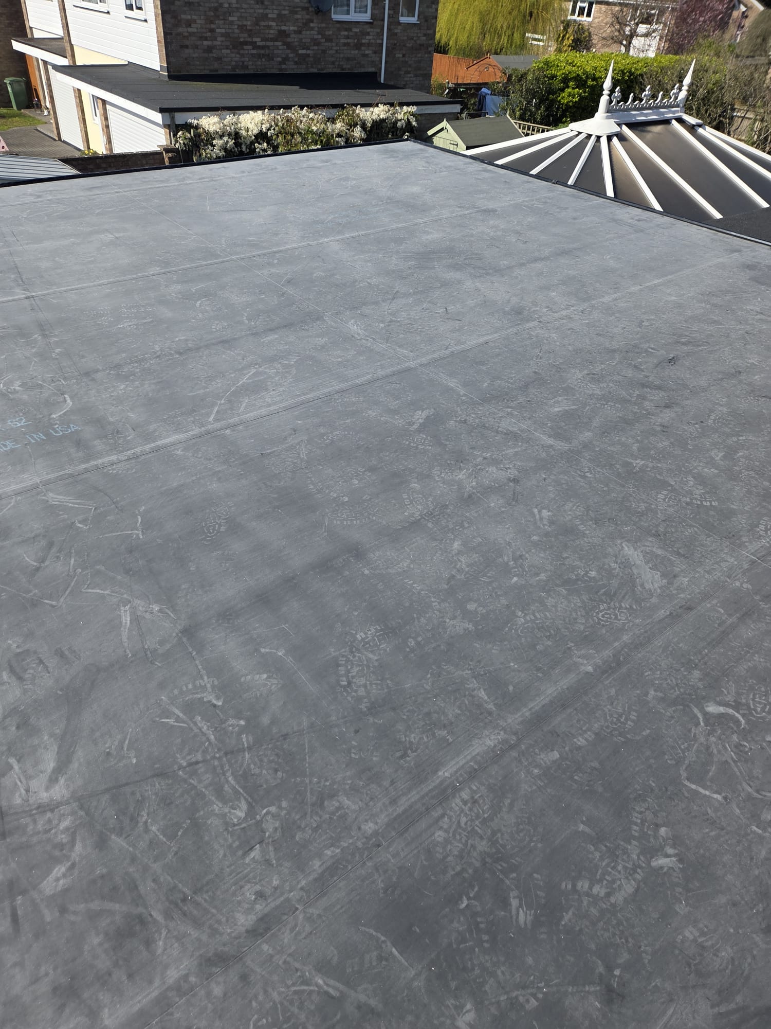 Aerial view of completed EPDM rubber flat roof on a residential property