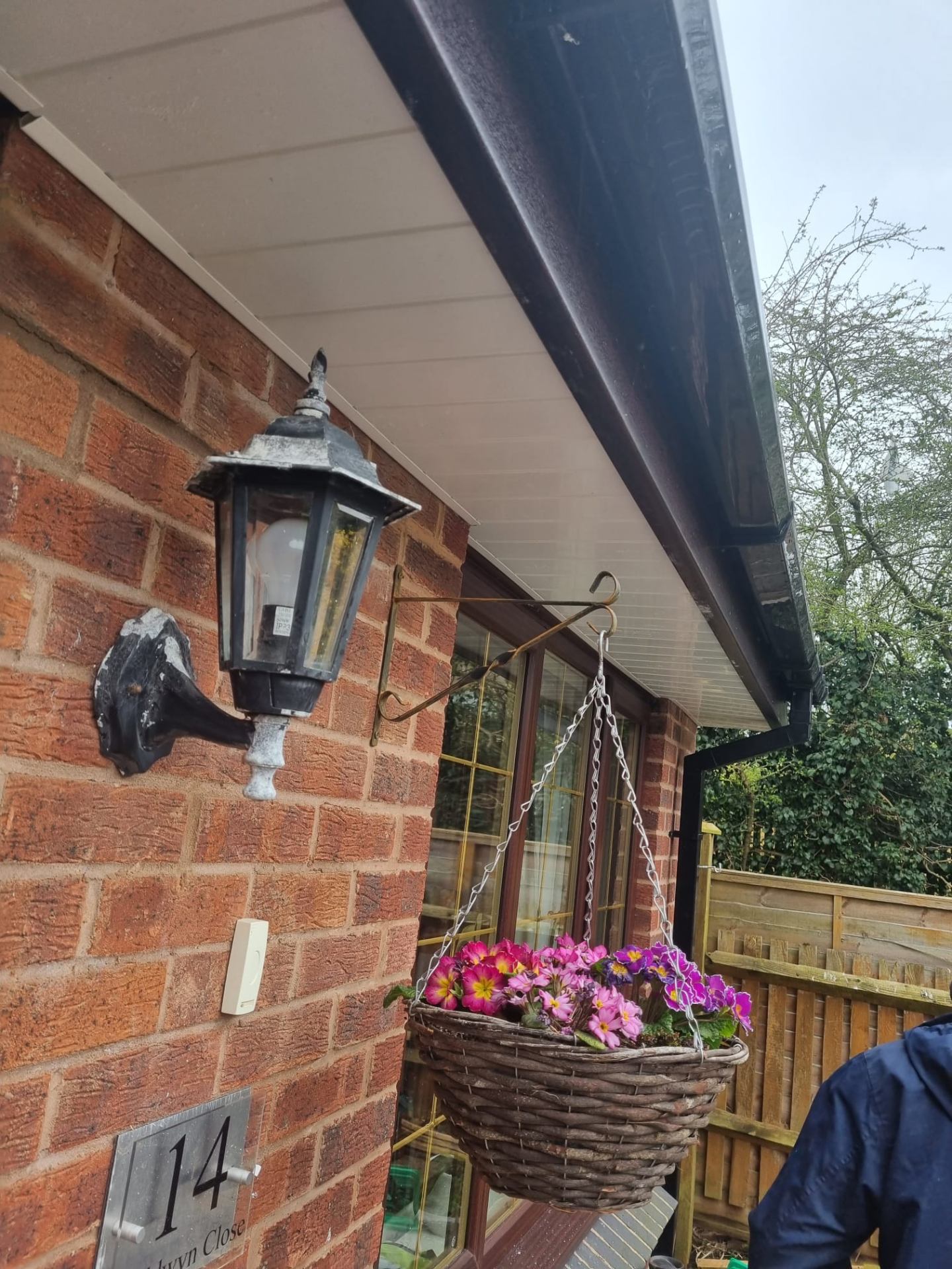 New black guttering and white soffit installed above a brick bungalow extension
