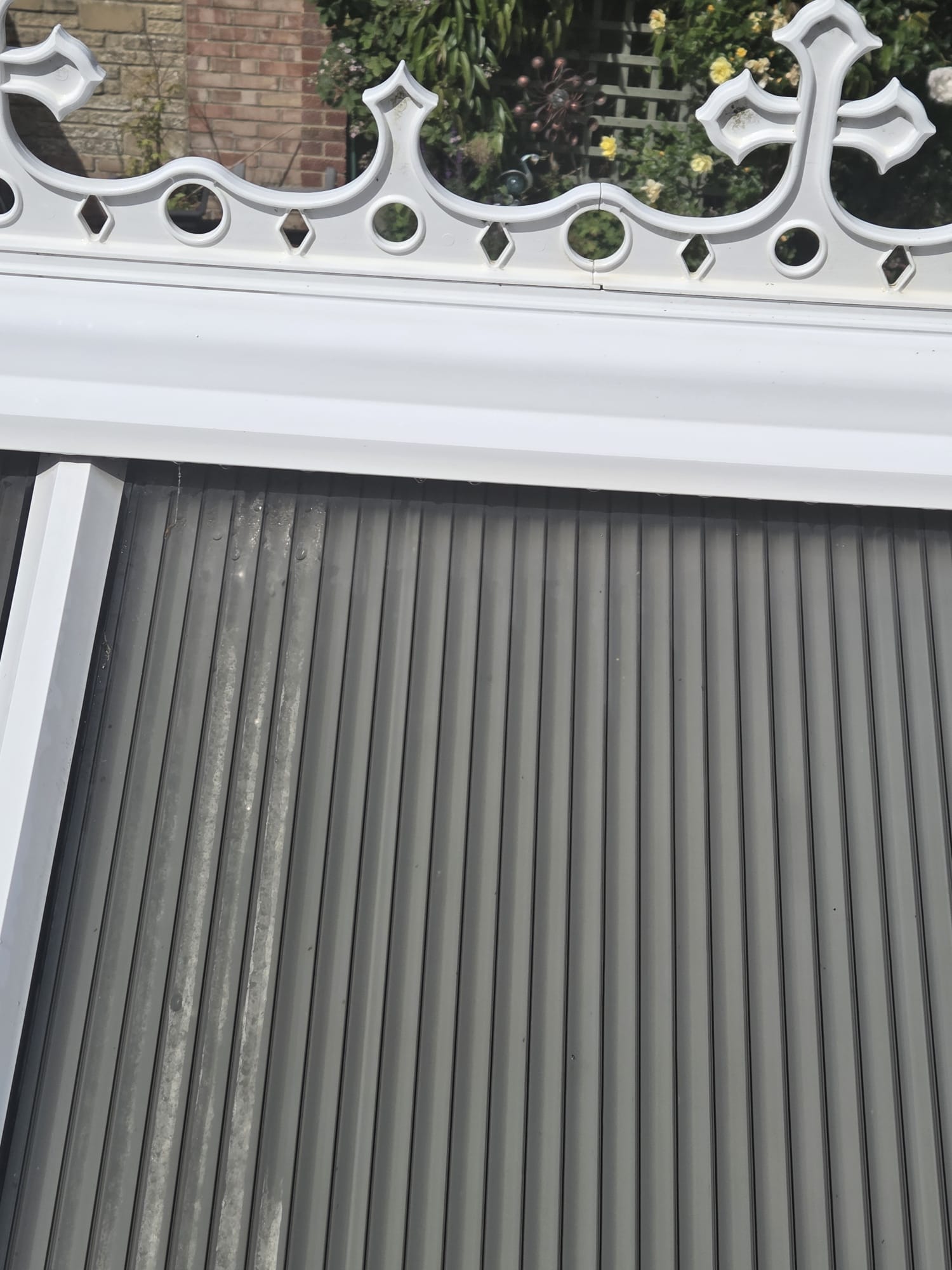 Conservatory roof and uPVC frame showing moss and algae build-up before cleaning