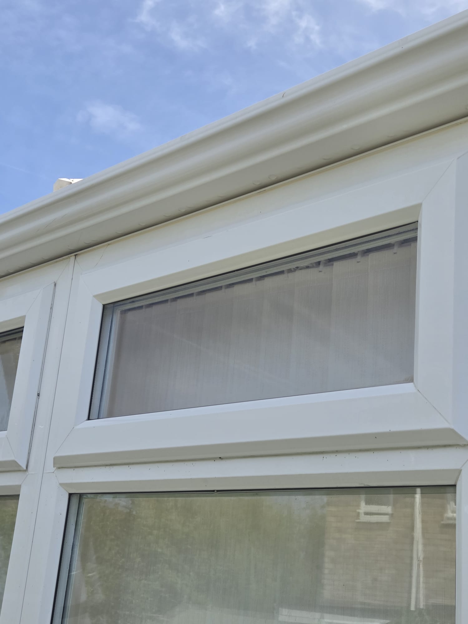 Conservatory window frames and guttering after exterior cleaning